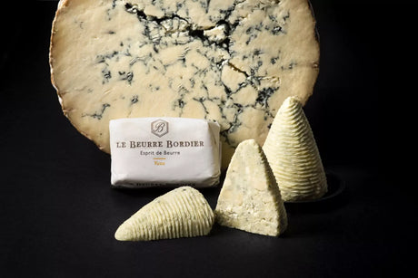 Maison Bordier yuzu butter and artisan French blue cheese on a dark background