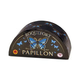 Papillon Roquefort blue cheese half-wheel with blue butterfly logo on black packaging