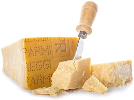 Wedge of Parmigiano Reggiano cheese with cheese knife, artisan premium quality